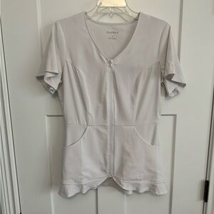 Original Jaanuu Scrub top with scalloped bottom.